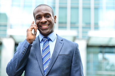Smiling man talking on a cell phone
